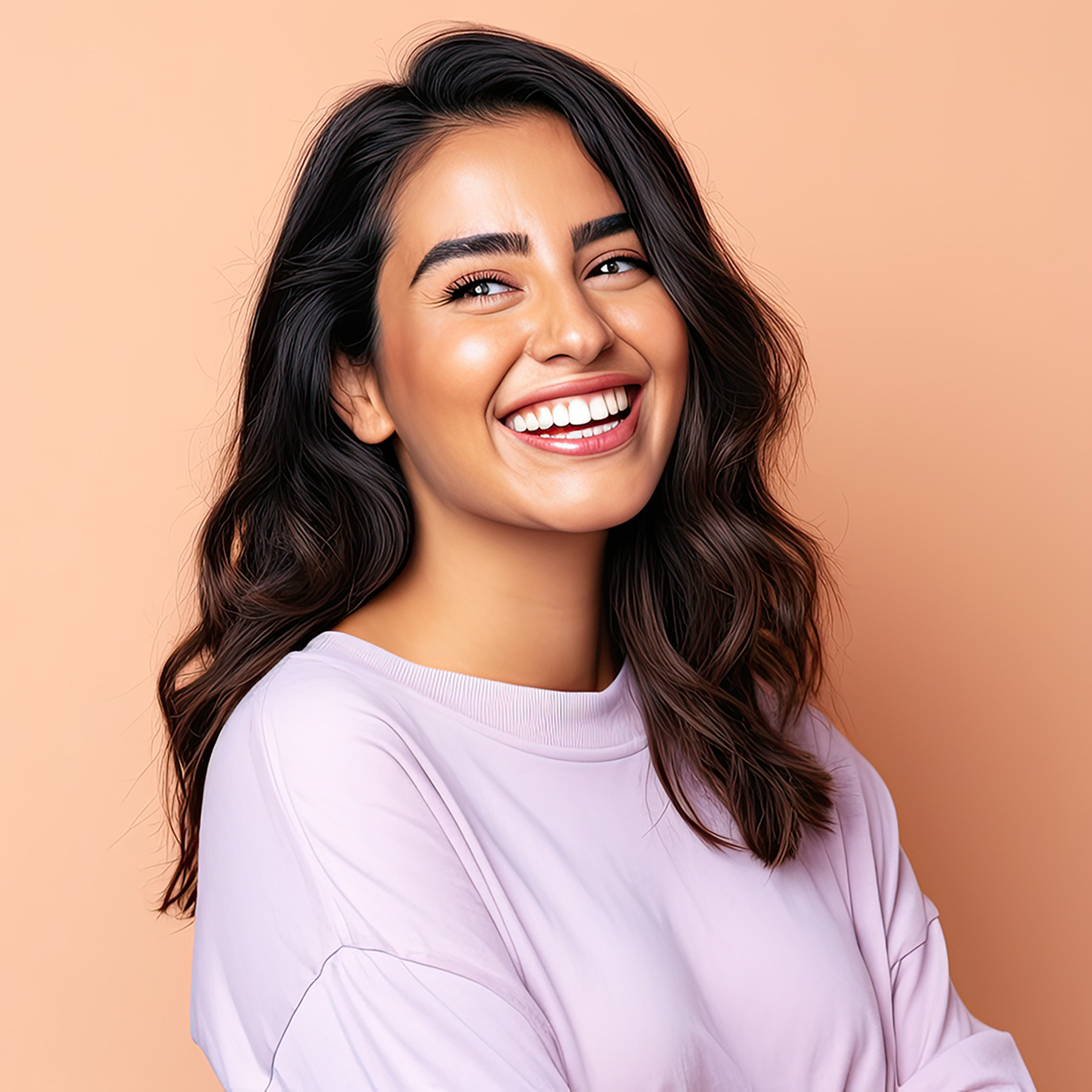 The image shows a woman with dark hair smiling at the camera against a light background.